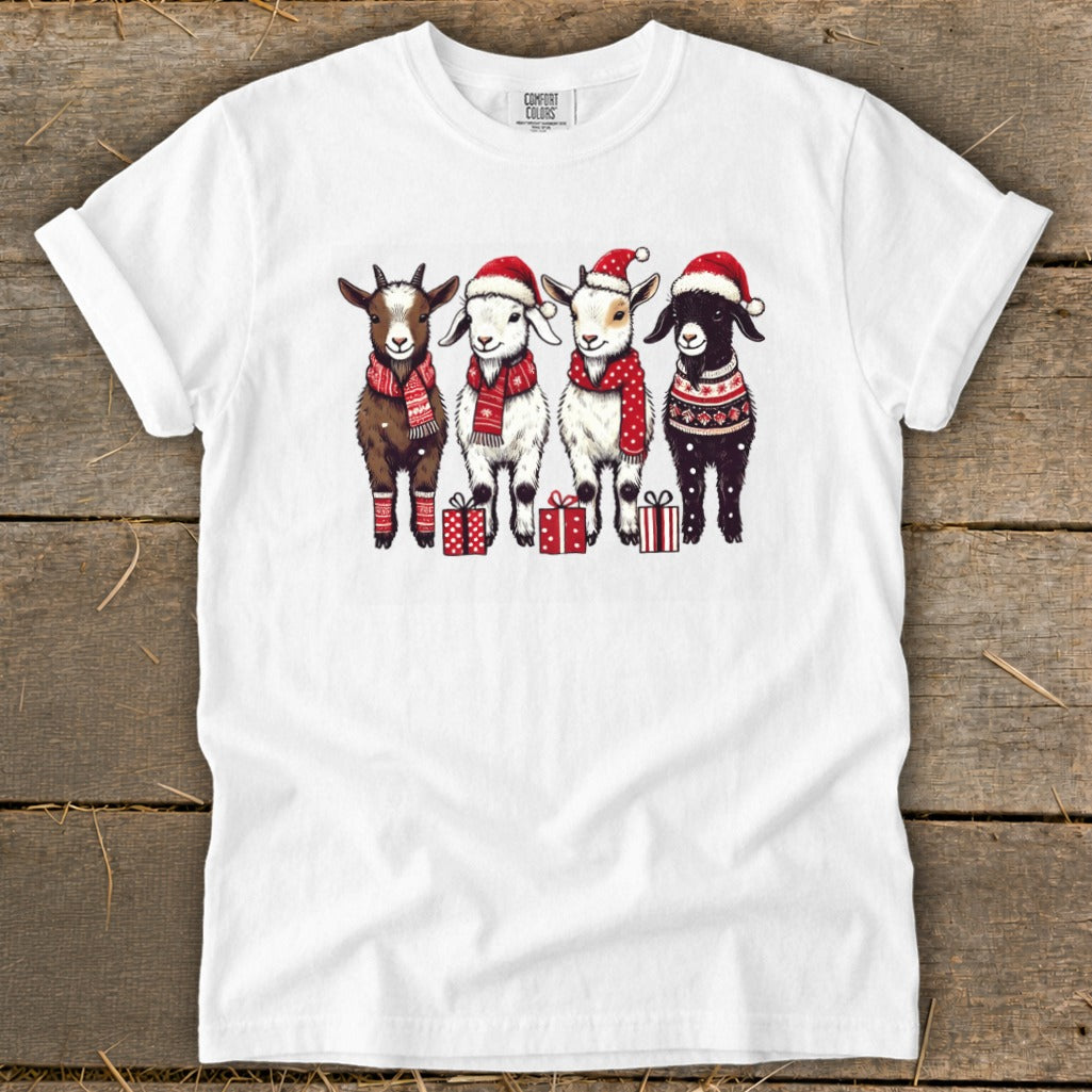 Four goats wearing Santa hats and scarves stand with gift boxes.