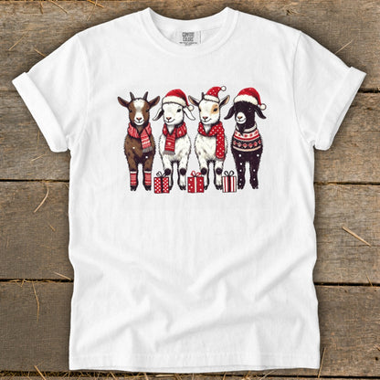 Four goats wearing Santa hats and scarves stand with gift boxes.