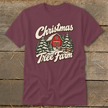 Maroon t-shirt with "Christmas Tree Farm" text over a red barn and snowy evergreen trees.