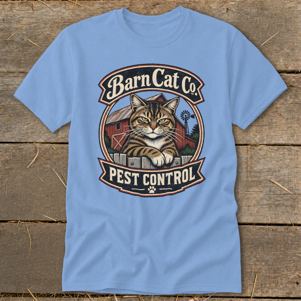 A light blue t-shirt featuring a circular graphic of a tabby cat and a barn with the text "Barn Cat Co. Pest Control".