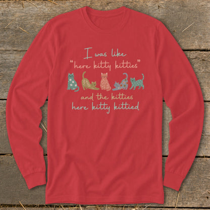 Red long-sleeve shirt with text "I was like 'here kitty kitties' and the kitties here kitty kittied" and cartoon cats.