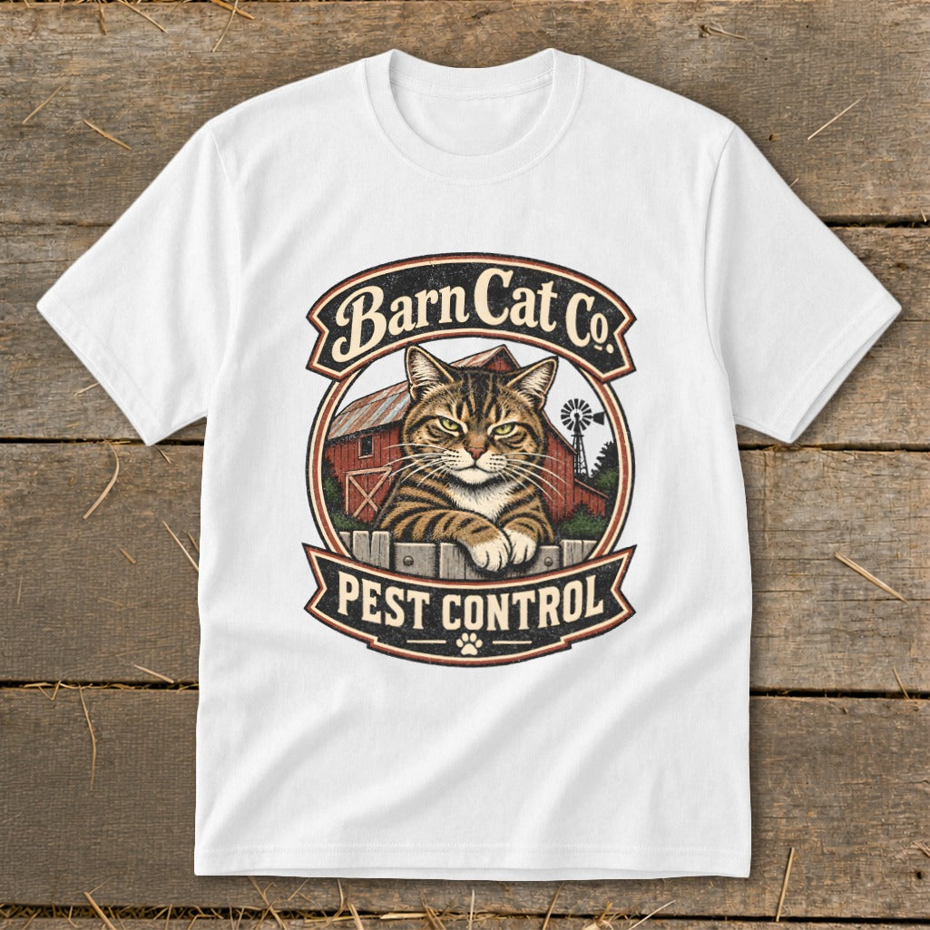 A white t-shirt featuring a circular graphic with a tabby cat, red barn, and text reading Barn Cat Co. Pest Control.