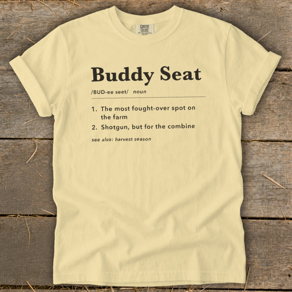 Yellow t-shirt with "Buddy Seat" definition: fought-over spot on farm, shotgun for combine.