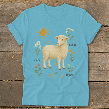 Light blue t-shirt with illustration of a lamb surrounded by flowers, sun, and wavy lines.
