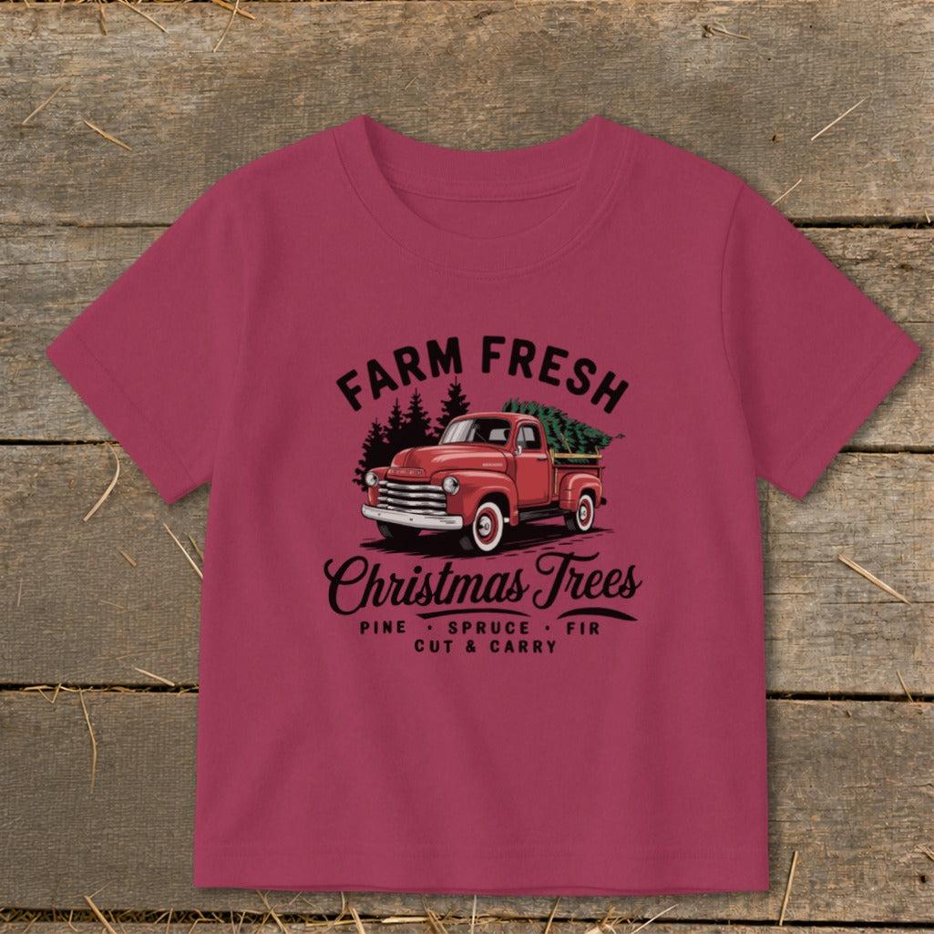 T-shirt with vintage red truck carrying Christmas trees and "Farm Fresh Christmas Trees" text.