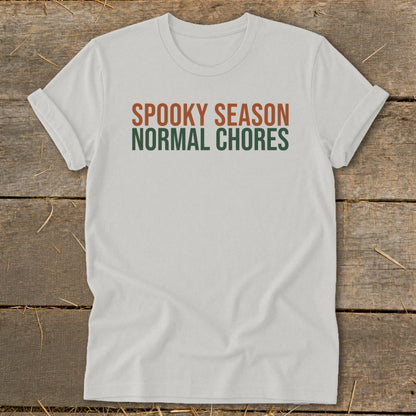 White t-shirt with "SPOOKY SEASON" and "NORMAL CHORES" text.