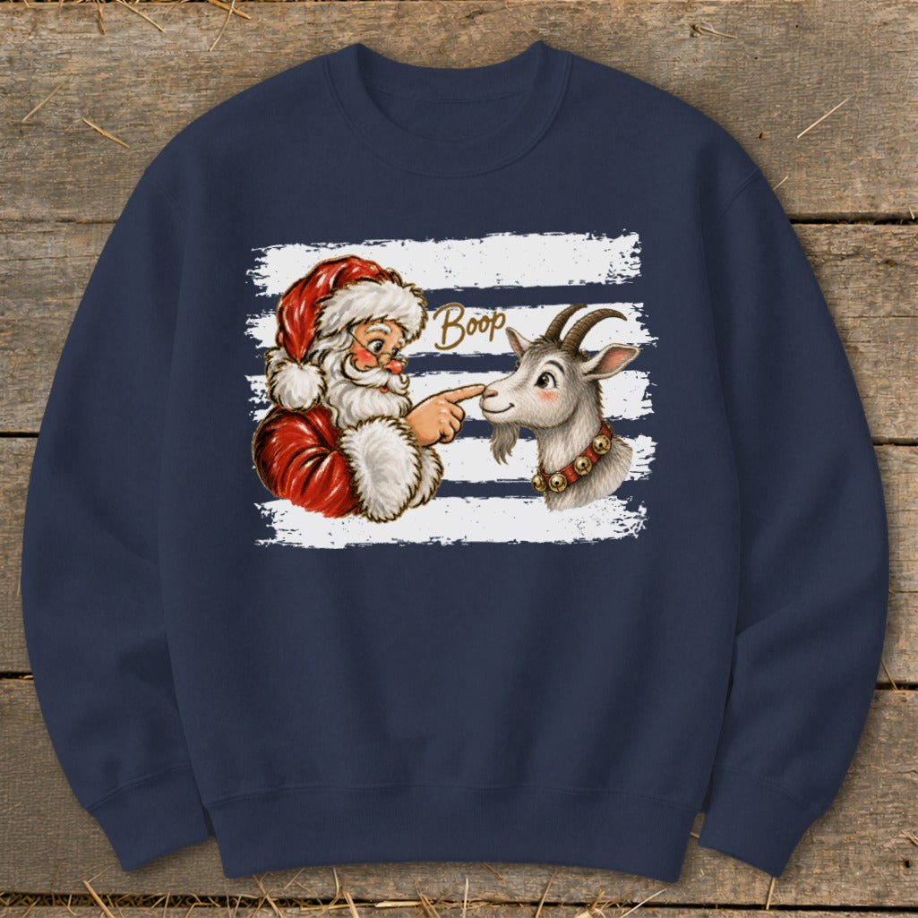 Santa playfully booping a goat's nose on a striped background.