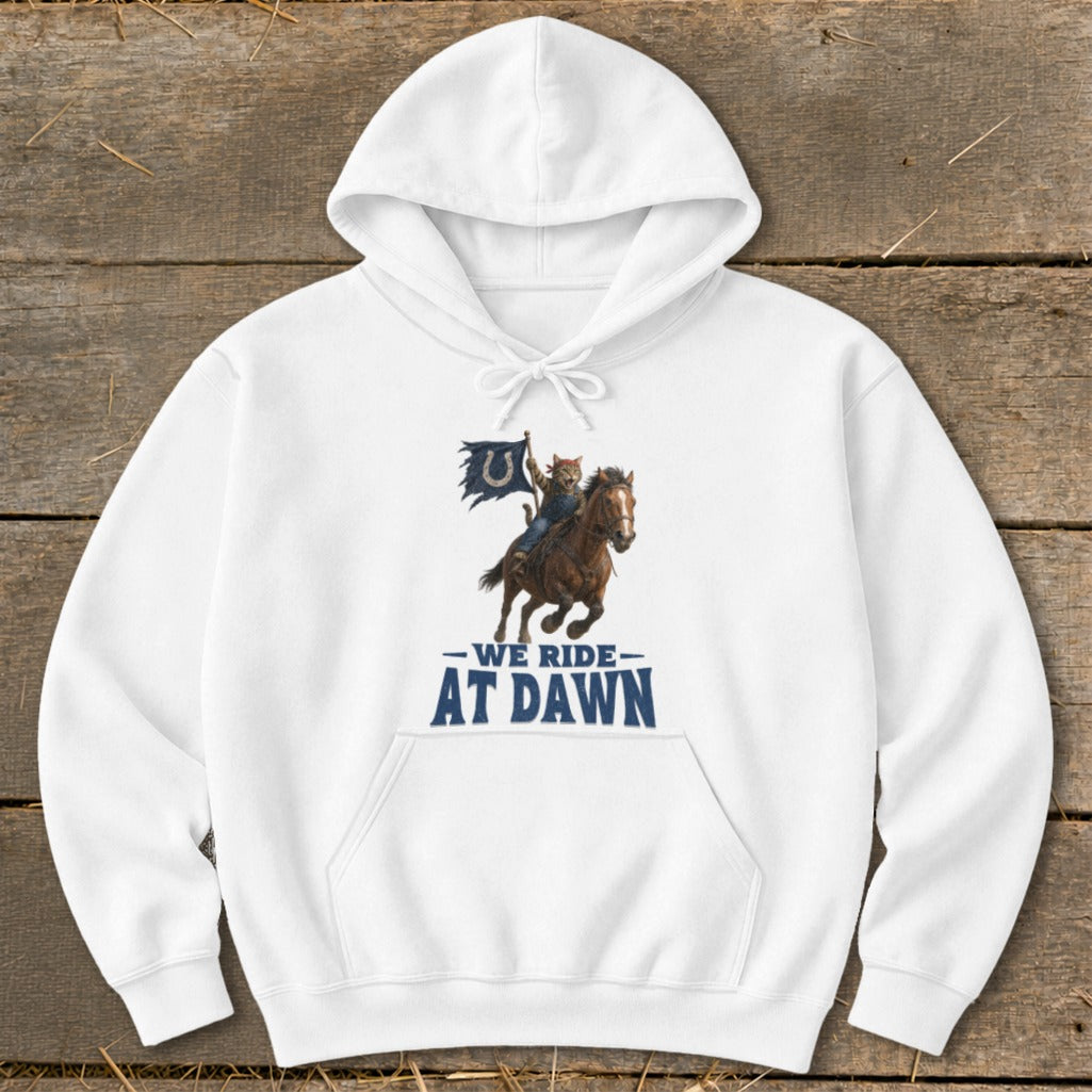 White hoodie with a graphic of a cat on a horse holding a Colts flag, reading "We Ride At Dawn."