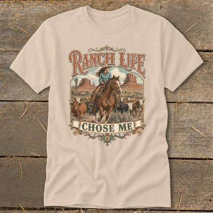Cream t-shirt with "RANCH LIFE CHOSE ME" text and cowboy riding horse with cattle.