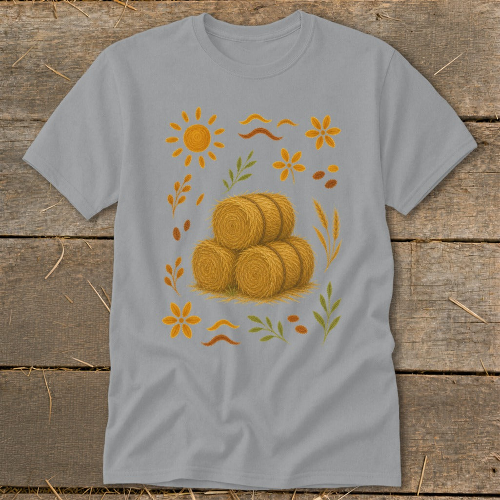 Grey t-shirt with a stack of hay bales and autumn-themed illustrations.