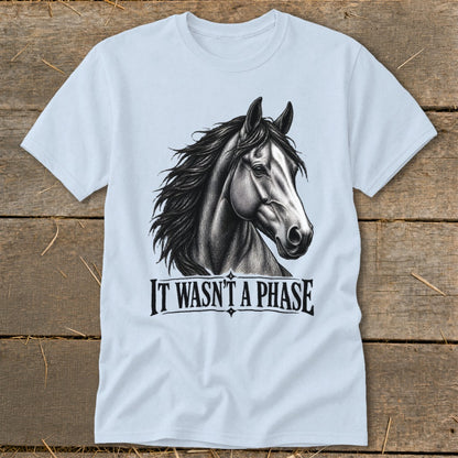 Light blue t-shirt with a black and white drawing of a horse's head and the text "IT WASN'T A PHASE".