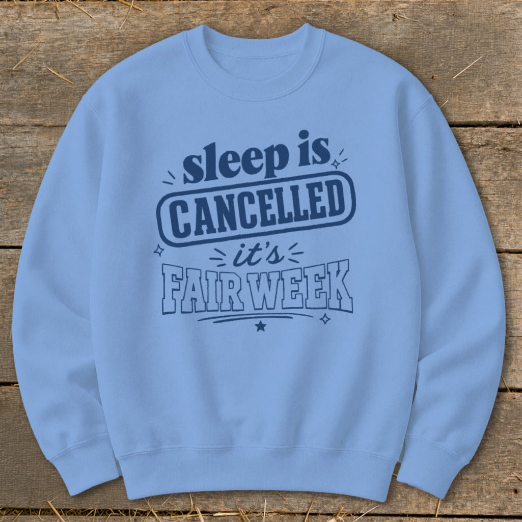 Light blue sweatshirt with dark blue text "sleep is CANCELLED it's FAIR WEEK."