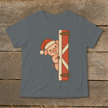 Pig in Santa hat peeking around a red barn door on a gray t-shirt.