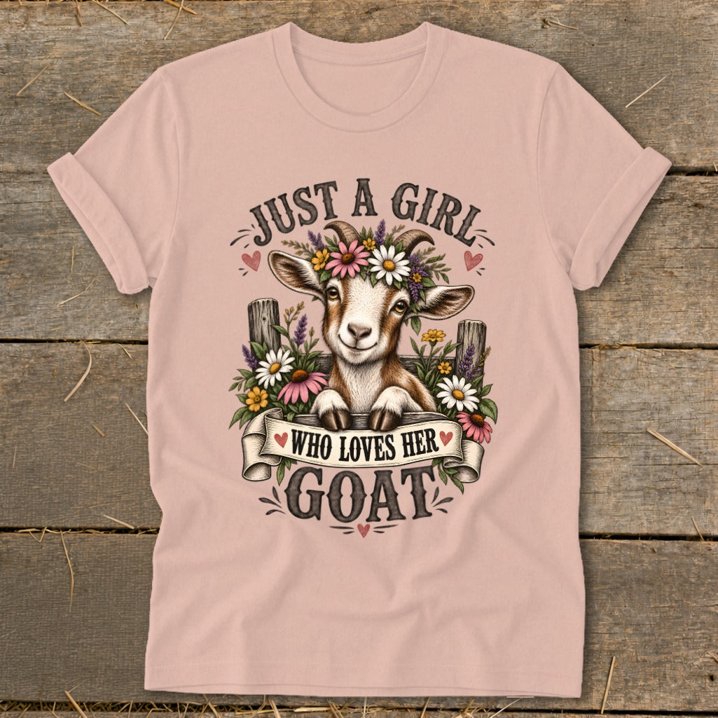 Pink t-shirt with graphic of a goat wearing flowers and text "JUST A GIRL WHO LOVES HER GOAT".