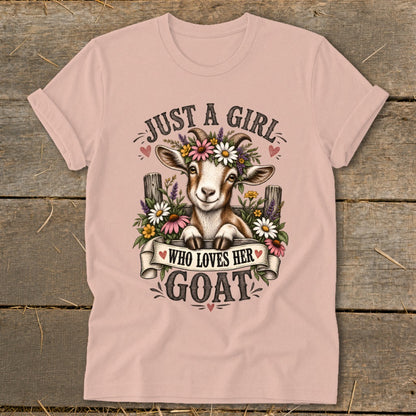 Pink t-shirt with graphic of a goat wearing flowers and text "JUST A GIRL WHO LOVES HER GOAT".