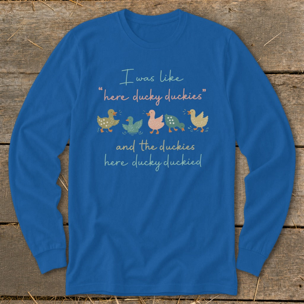Blue long sleeve shirt with ducks and the phrase "here ducky duckies".