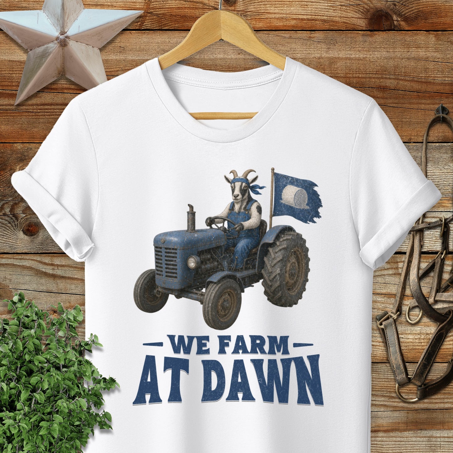 Blue tractor with goat driver and flag, text "We Farm At Dawn".