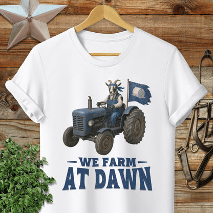 Blue tractor with goat driver and flag, text "We Farm At Dawn".
