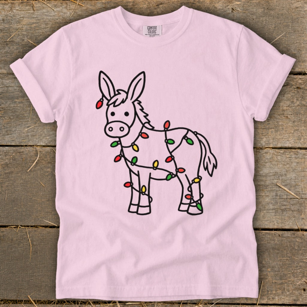 Pink t-shirt with a black outline drawing of a donkey wrapped in colorful Christmas lights.