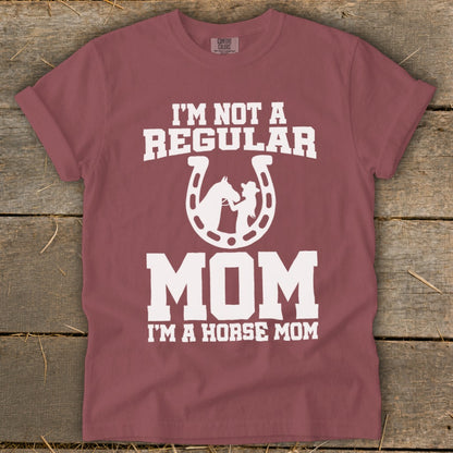 Maroon t-shirt with white text and graphic: "I'M NOT A REGULAR MOM I'M A HORSE MOM."