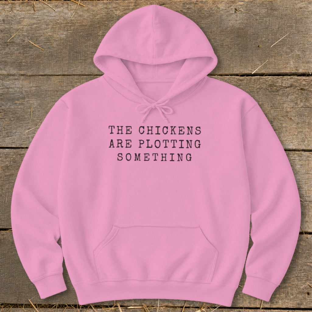Pink hoodie with text "THE CHICKENS ARE PLOTTING SOMETHING".