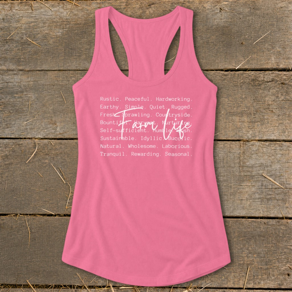 Pink racerback tank top with white text "Farm Life" and descriptive words.