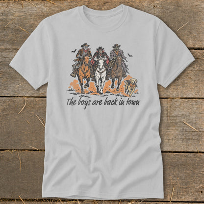 Three spooky cowboys on horses, a dog runs alongside, with "The boys are back in town" text.
