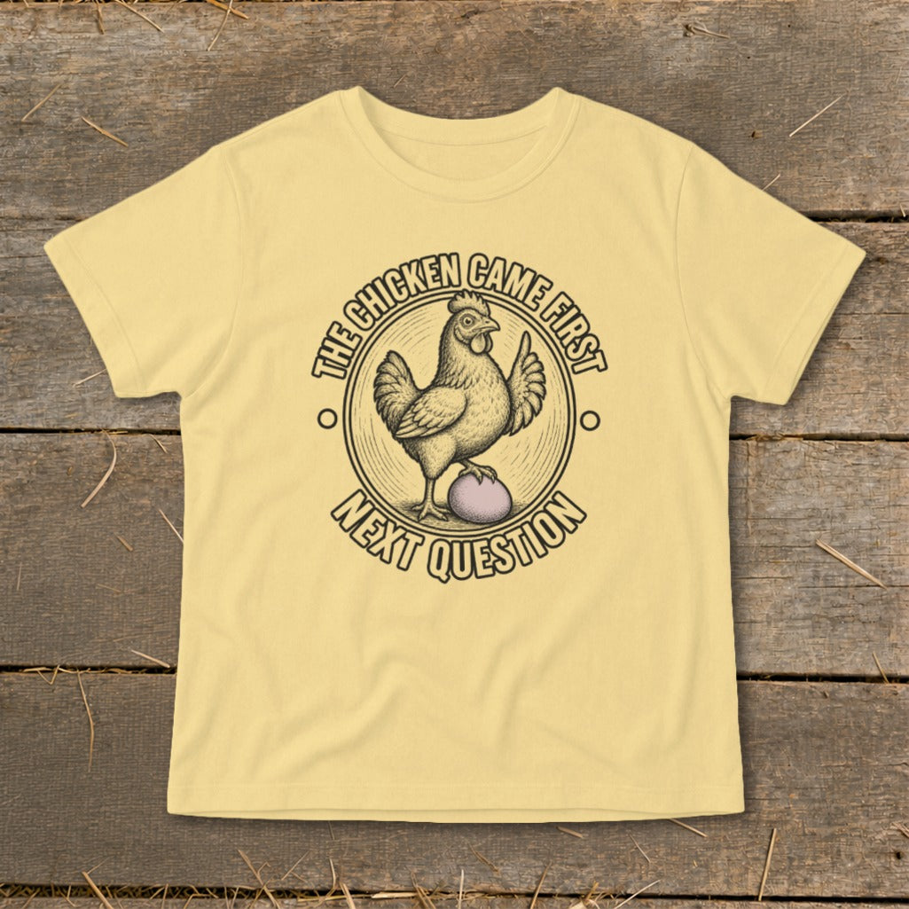 Yellow t-shirt with a chicken and egg graphic and text "The chicken came first, next question".
