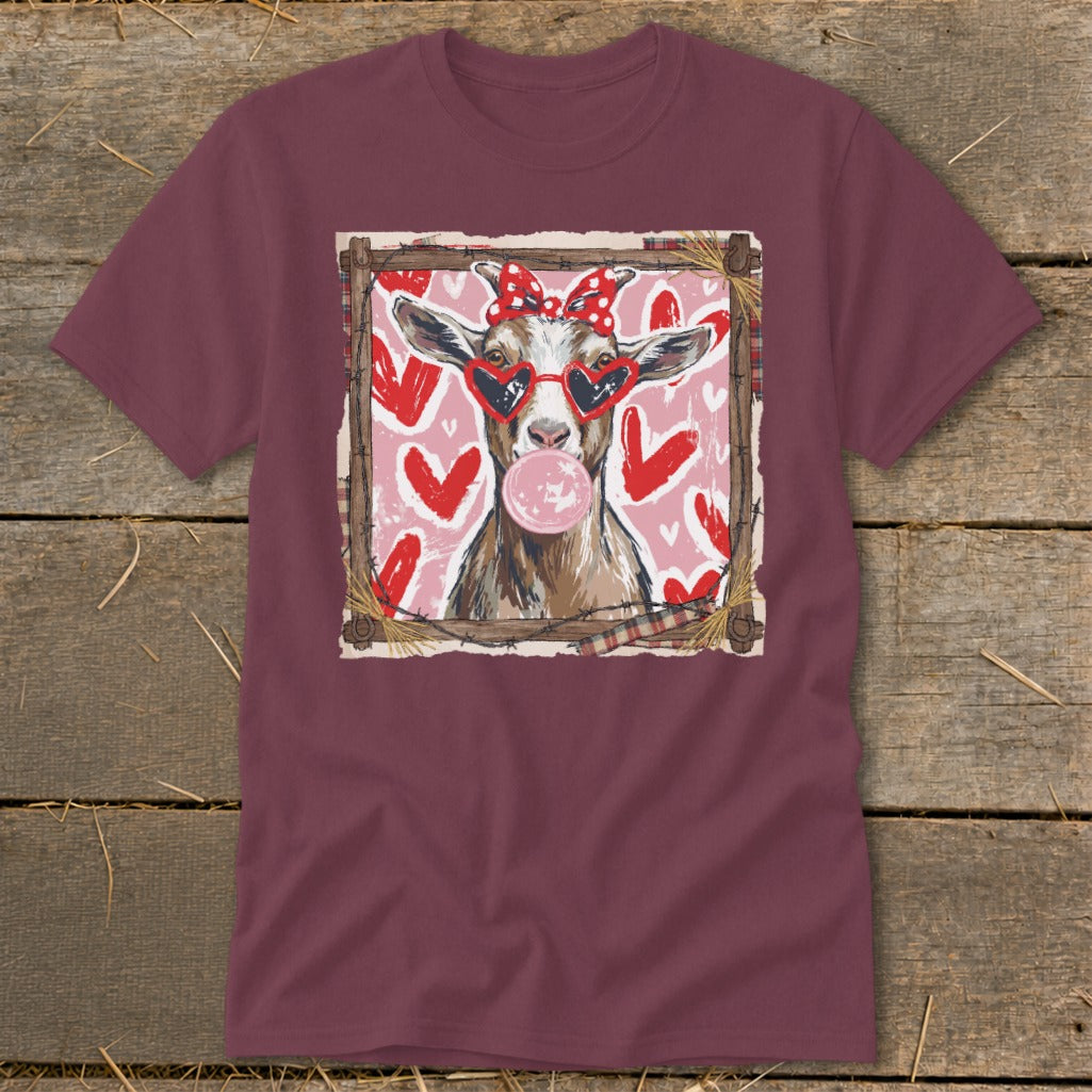 Goat with heart sunglasses and red bow blowing bubblegum, on pink hearts background.