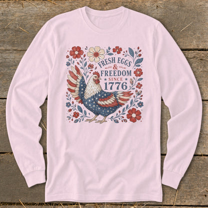 Long sleeve pink shirt with patriotic chicken graphic, fresh eggs, freedom, since 1776 text.