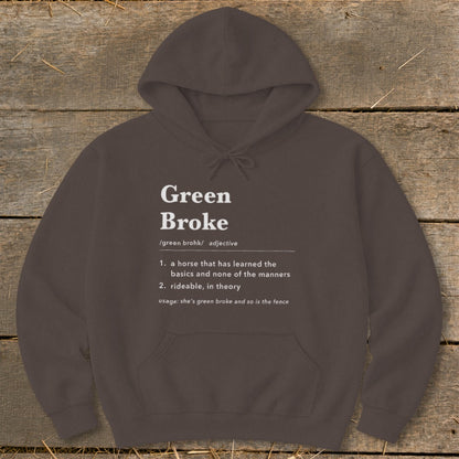 Dark brown hoodie featuring white dictionary-style text defining the phrase Green Broke against a wooden background.