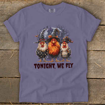 Three chickens in witch hats stand before a spooky house with text that reads "TONIGHT, WE FLY."