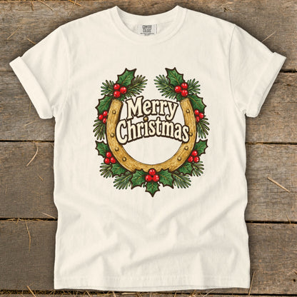 White t-shirt with a horseshoe wreath graphic saying "Merry Christmas".