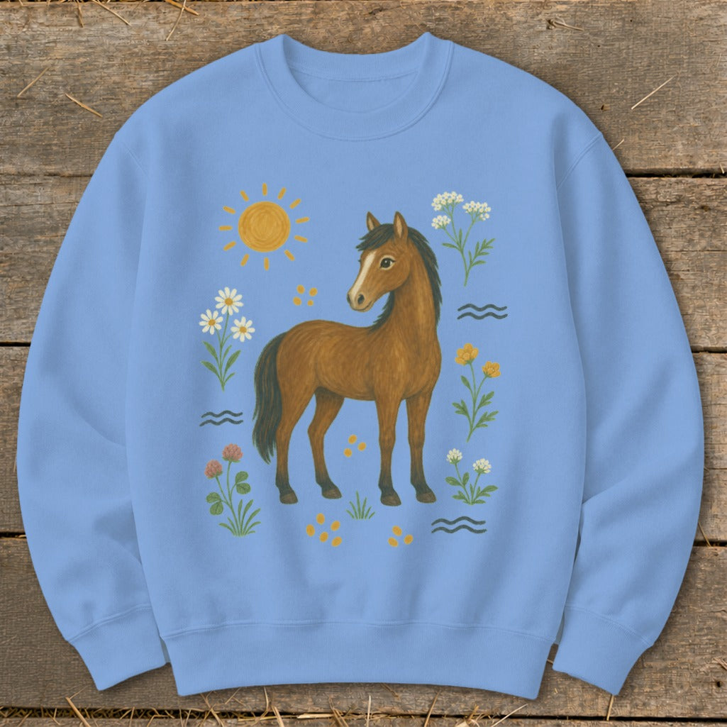 Light blue sweatshirt with a brown horse, sun, and floral illustration.