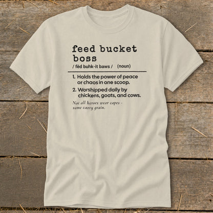 Light tan t-shirt with "feed bucket boss" definition including chickens, goats, and cows.