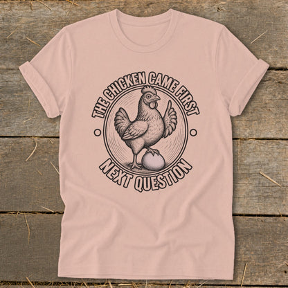 Chicken came first next question graphic on a pink t-shirt