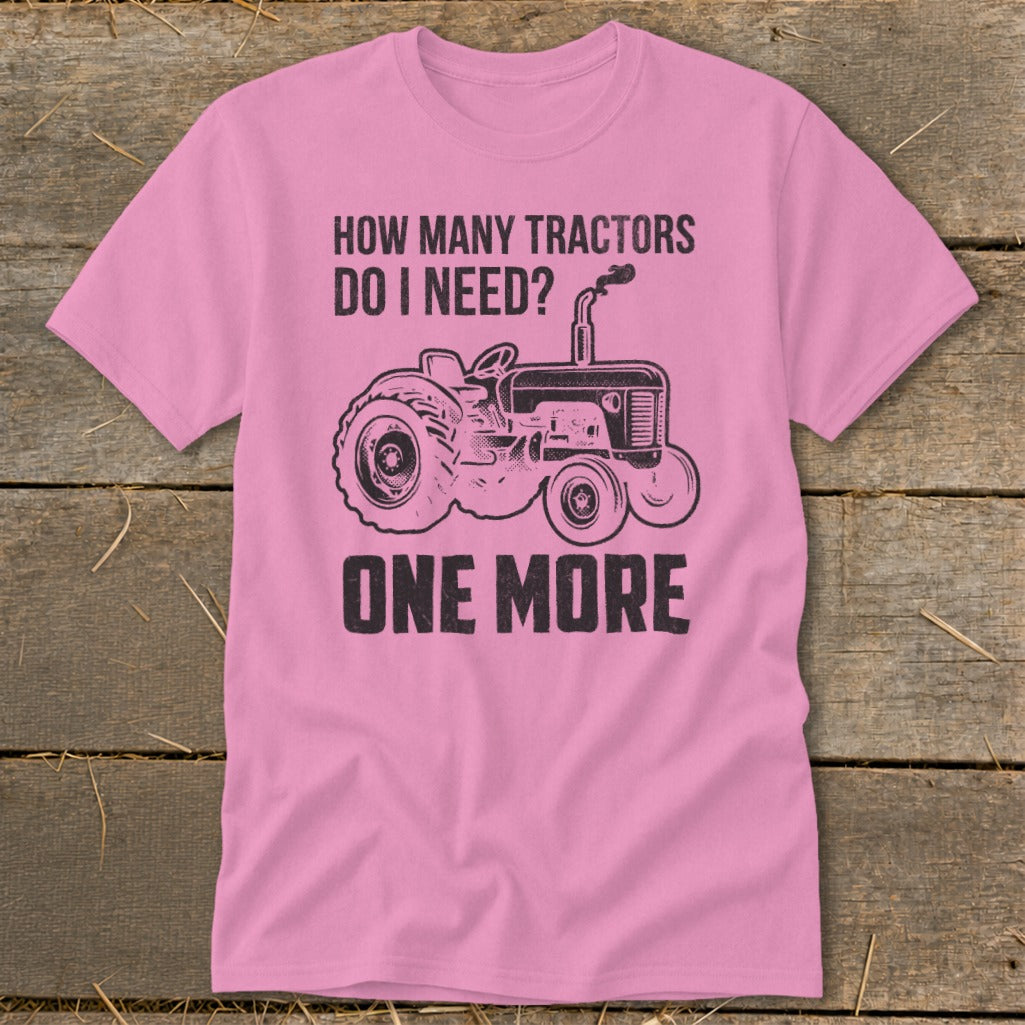 Pink t-shirt with graphic and text: "How many tractors do I need? One more."