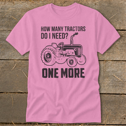 Pink t-shirt with graphic and text: "How many tractors do I need? One more."