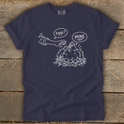 Navy t-shirt with white line drawing of a hen protecting her eggs, saying "MINE".