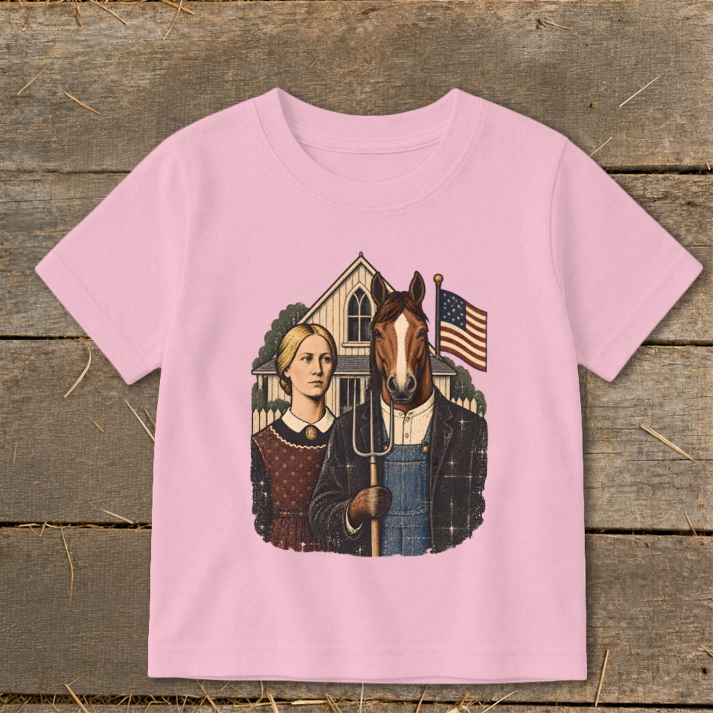 Pink t-shirt featuring a parody American Gothic graphic with a horse-headed farmer holding a pitchfork.