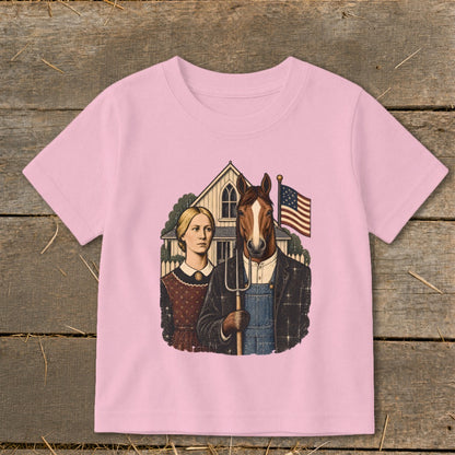Pink t-shirt featuring a parody American Gothic graphic with a horse-headed farmer holding a pitchfork.