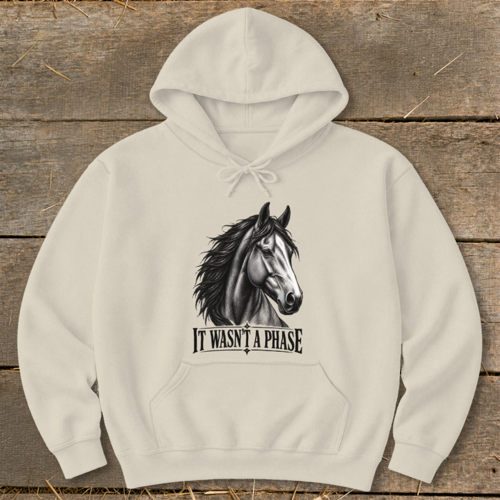 Cream hoodie with black and white horse graphic and text "IT WASN'T A PHASE".