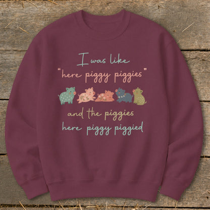 Burgundy sweatshirt with text "I was like 'here piggy piggies' and the piggies here piggy piggied" and cartoon pigs.