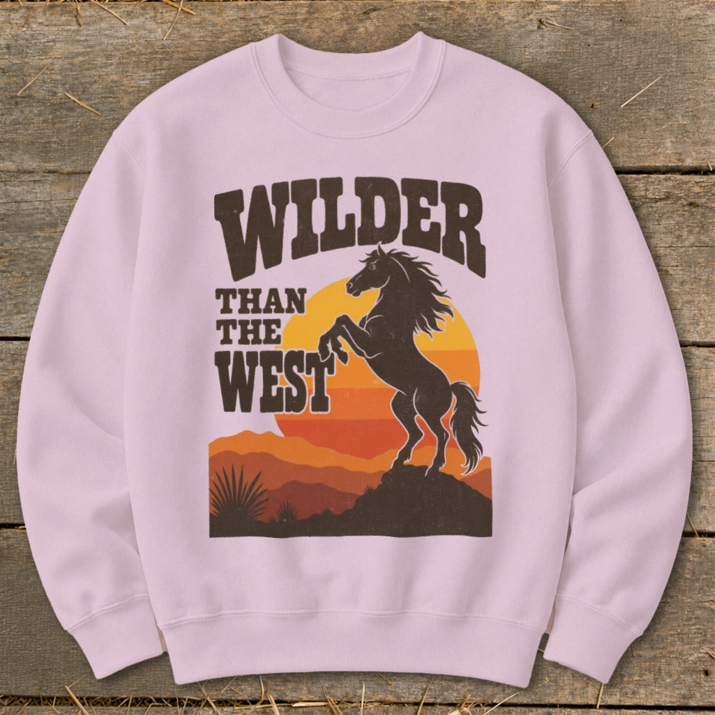 Light pink sweatshirt with "Wilder Than The West" text and a rearing horse graphic.
