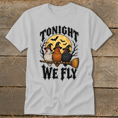 Three chickens in witch hats ride a broomstick under "Tonight We Fly" text.