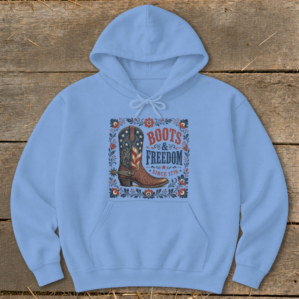 Light blue hoodie with "Boots & Freedom Since 1776" text and American flag cowboy boot graphic.