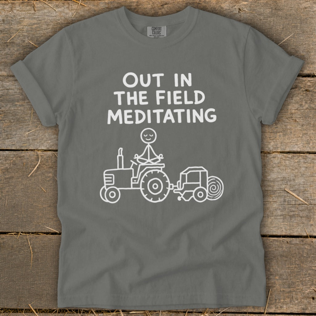 White graphic of a figure meditating on a tractor with text "Out in the field meditating".