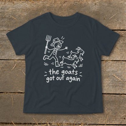 Dark t-shirt with a graphic of a farmer chasing goats and text "the goats got out again".