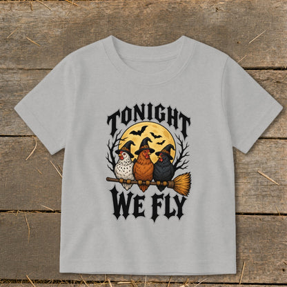 Three chickens in witch hats ride a broomstick with "Tonight We Fly" text.