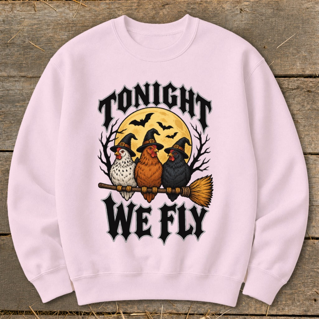Three chickens wearing witch hats ride a broomstick under a full moon with text "TONIGHT WE FLY".